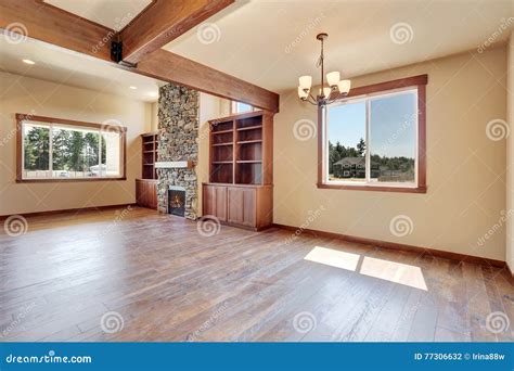 Empty Living Room with Hardwood Floor, Stone Fireplace and Wooden Shelves. Stock Photo - Image ...