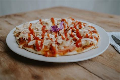 Premium Photo | A pizza with a purple flower on it