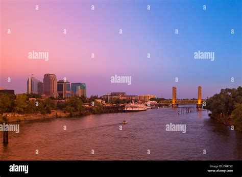 The Sacramento city skyline, including the Delta King riverboat and the Tower Bridge at sunset ...