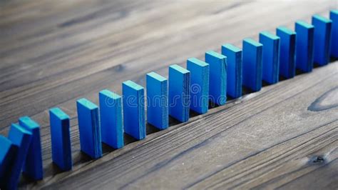 3D Rendered Blue Domino Tiles Falling in Lines on a Wooden Floor Stock ...