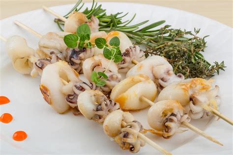 Grilled cuttlefish on the plate and wooden background 12685476 Stock Photo at Vecteezy