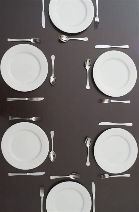 Dark table set with clean white plates and cutlery - Free Stock Image