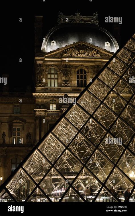 Louvre Behind Glass Pyramid at Night Stock Photo - Alamy