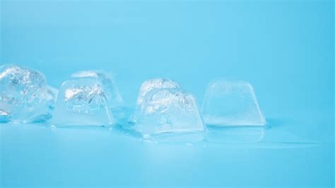 Premium Photo | Ice cubes closeup on blue background