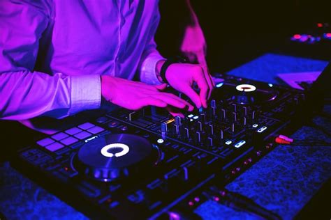 Premium Photo | Dj mixes electronic music with his hands on a music ...
