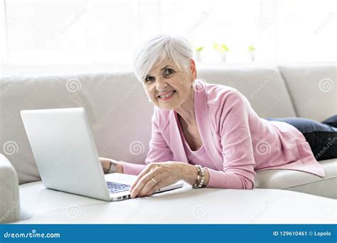 Retired Senior Woman Sitting at Home Using Her Laptop Stock Image - Image of mature, casual ...