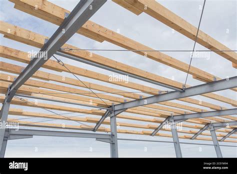 Roof construction from timber beams and steel frames. Agricultural ...