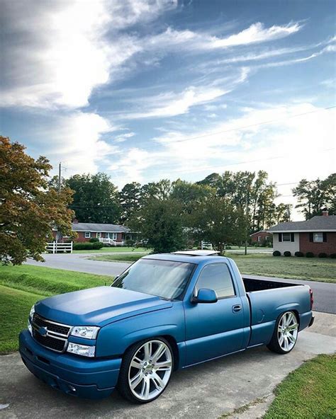 Blue Chevy Pickup Truck Parked Next to a House