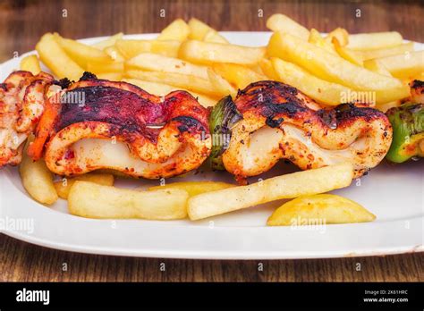 Grilled squid skewer with vegetables Stock Photo - Alamy