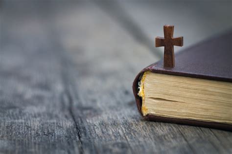 Premium Photo | Cross and bible on a wood background.