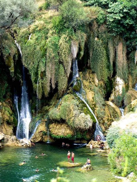 Kravice waterfalls, Bosnia and Herzegovina. I crawled behind the overgrown vegetation of one of ...