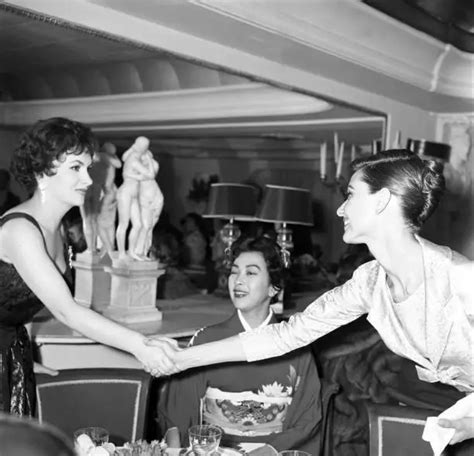 GINA LOLLOBRIGIDA SHAKING hands with British actress Audrey Hepburn ...