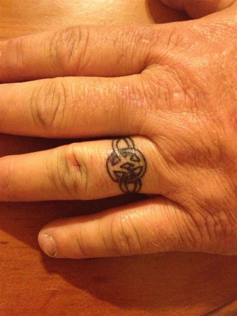 Pin by Brittany Norton on Tattoos | Tattoo wedding rings, Wedding ring tattoo for men, Ring tattoos