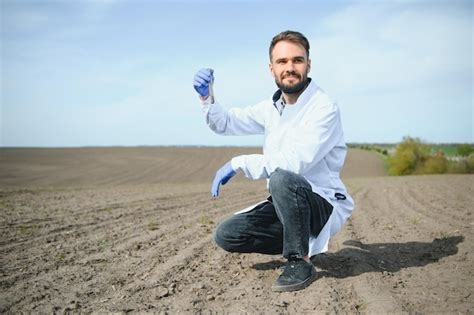 Premium Photo | Agronomist studying samples of soil in field