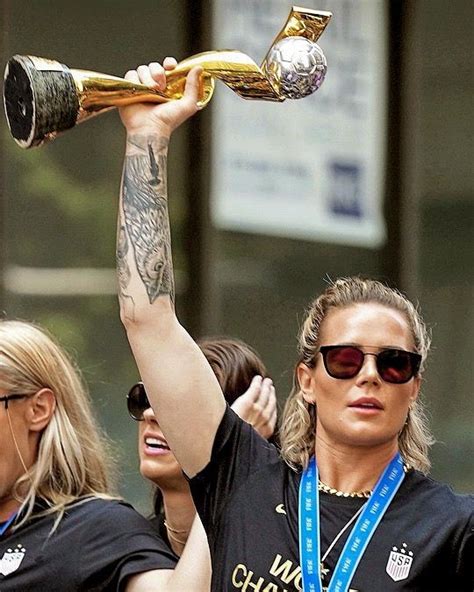 a woman holding up a trophy in the air