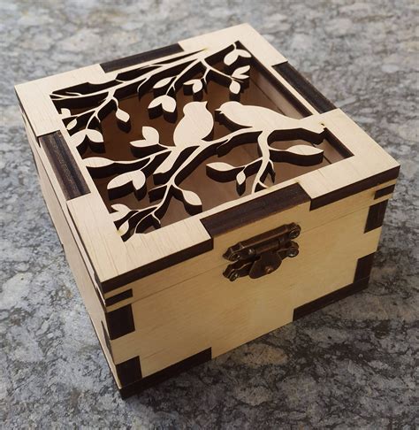 a wooden box with an intricate design on the lid