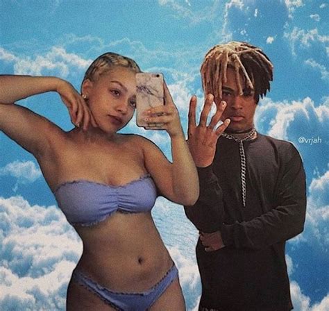 a man taking a selfie next to a woman in a bathing suit with clouds behind her