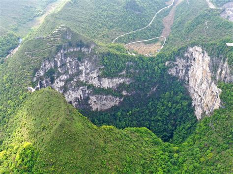 A giant sinkhole in China has an ancient forest growing inside : NPR