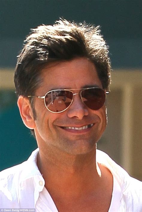 John Stamos flashes his cheeky tooth(less) smile whilst running errands ...