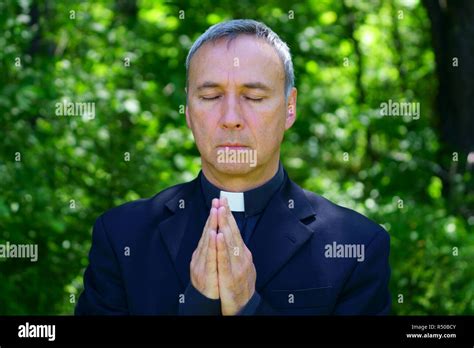 Praying hands priest hi-res stock photography and images - Alamy