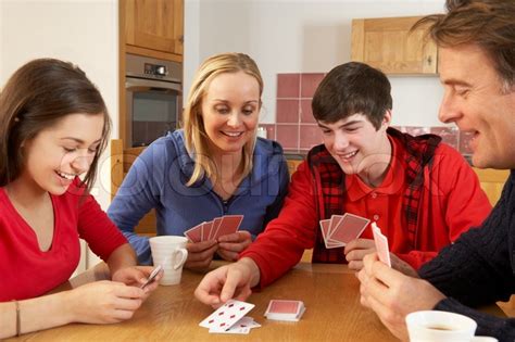 Family Playing Cards In Kitchen | Stock Photo | Colourbox