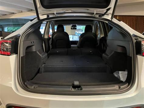 The rear cargo area in the 7-seat Model Y is completely flat thanks to ...