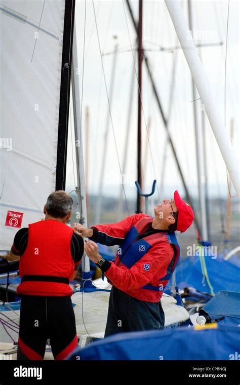 Two men prepare a sailing dinghy, Whitstable Yacht Club Kent, England, UK Stock Photo - Alamy