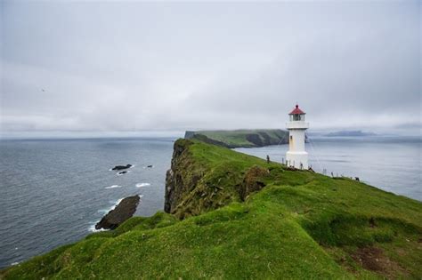 Premium Photo | Mykines lighthouse, faroe islands. foggy view of old lighthouse