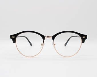 Clubmaster style glasses, black half frame with gold underwire. Browline classic vintage design ...
