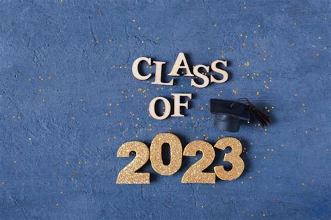 Premium Photo | Class of 2023 banner concept wooden number 2023 with graduated cap on podium on ...