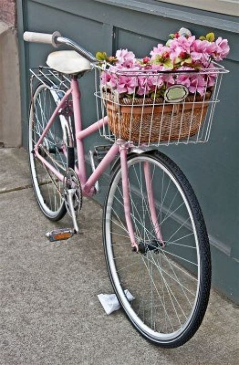 This vintage pink girls bicycle has beautiful pink flowers in a basket ...