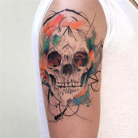 Abstract skull tattoo on the right upper arm.