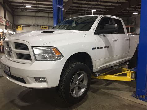 White Dodge Ram getting a leveling kit installed at CPW Truck Stuff in Tinley Park Custom Jeep ...