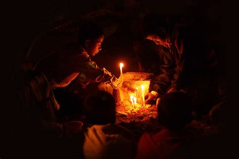 all souls’ day | kids lighting candles at the grave of their… | Flickr