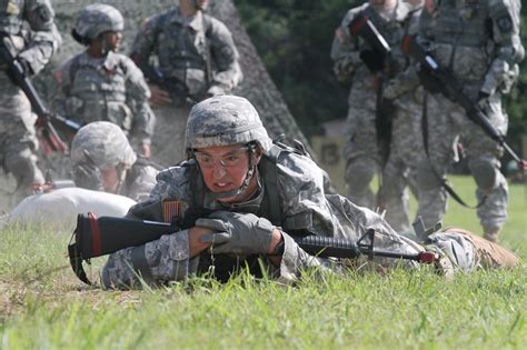 An Army cadet pushes himself through the low-crawl portion during ...