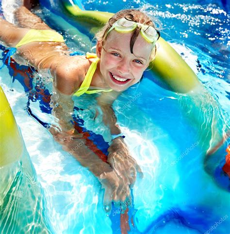 Child on water slide at aquapark. — Stock Photo © poznyakov #9079133