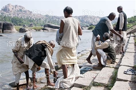 Group Of Indian Men Washing In River From Ghat Stock Photo - Download Image Now - Adult ...