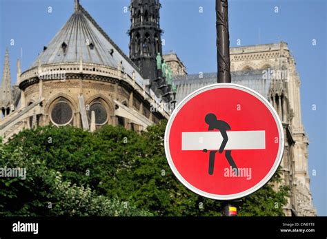 Paris, France. No Entry sign by Notre Dame cathedral - 'enhanced' by Clet Abraham - man carrying ...