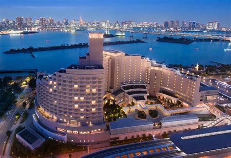 an aerial view of a large building in the middle of a body of water at night