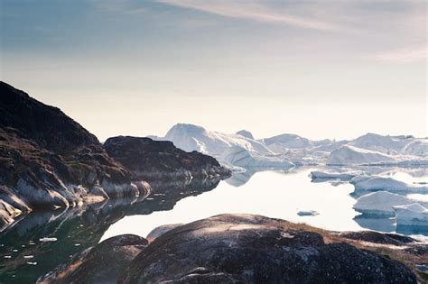 Premium Photo | Big icebergs in ilulissat icefjord at sunset. ilulissat ...