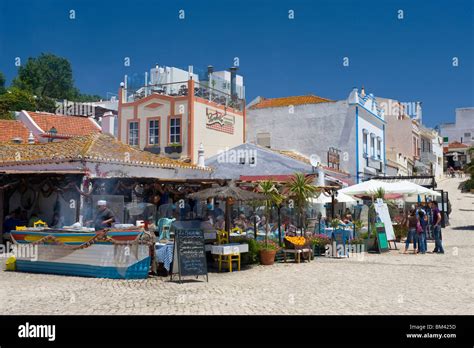 Portugal, The Algarve, Alvor Street Scene With Fish Restaurants Stock Photo - Alamy