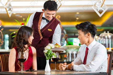 Chinese waiter serving dinner in elegant restaurant or Hotel - stock ...