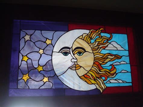 the sun and moon are depicted in this stained glass window