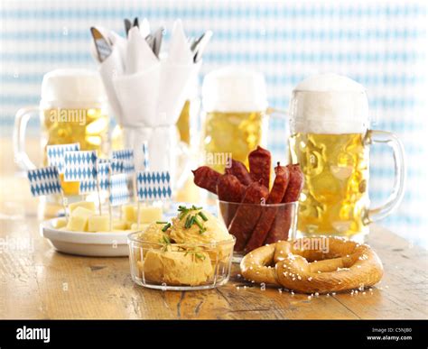 Pretzel, bavarian cheese spread, cheese sticks, sausages and beer Stock ...