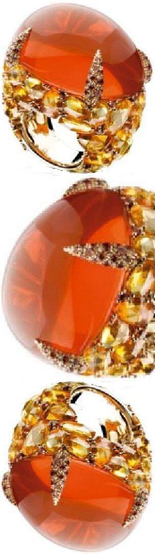 an orange glass object with gold accents