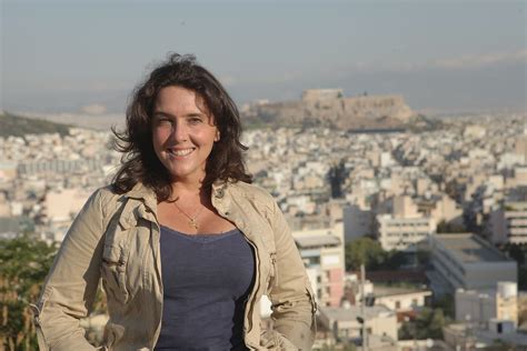 a woman standing in front of a cityscape