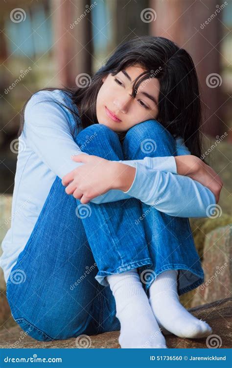 Sad Teen Girl Sitting On Rocks Along Lake Shore, Lonely Expression ...