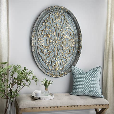 Elegance comes in the form of the 'Gold Ornate Oval Metal Wall Plaque ...