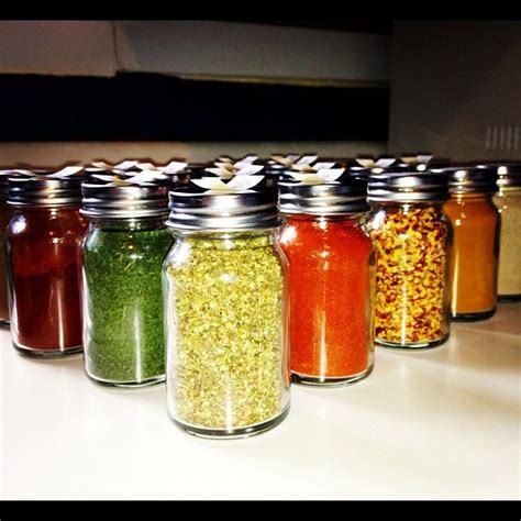 DIY spice rack. Glass bottles from World Market. Our labels are handwritten but you could use a ...