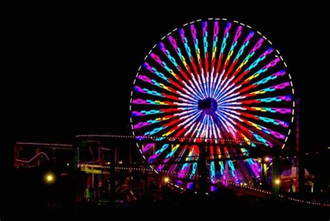 a ferris wheel lit up in the dark